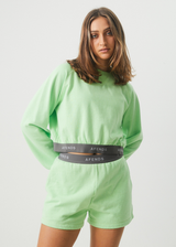 AFENDS Womens Homebase - Cropped Crew Neck Jumper - Lime Green - Https://player.vimeo.com/progressive_redirect/playback/722430149/rendition/1080p/file.mp4?loc=external&signature=cf2ef3b11fe99b35a599fea11784d24c0d562307a5422f1c47780e14116e8600